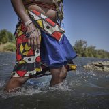 Kahakojo Katjeja at Kunene river which she crossed when she migrated from Angola due to the drought causing hunger in their villages.