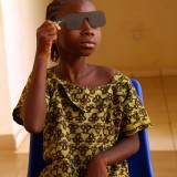 A young girl has her eyes tested in Malawi.