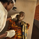 A women has her eyes checked at an eye camp in Uganda.