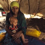 Portrait of Raho, 18, and her malnourished son struggle to find clean water