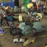 A child lies exhausted after walking for days to reach safety in Maban, South Sudan.