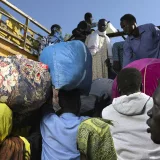 Returnees scramble to get themselves onto a truck which will transport them to the White Nile. From there, they will start their long journey home to various regions of South Sudan.