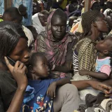 Sabrin, 16, ( centre ) patiently sits with her family in an overcrowded a boat that will transport them and many others along the White Nile to Malakal. They are trying to get home to Juba after leaving Sudan due to conflict.