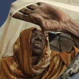 Fatima Mohammed Ali, 80 years old, shields herself from the sun at a camp in Mogadishu.