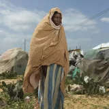 Faduma Ibrahim Haasi stands by the camp that she now lives in since the floods washed away her home.