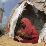 Janaay Nor Abdi sits with her sick child at Dugul Camp in Mogadishu.